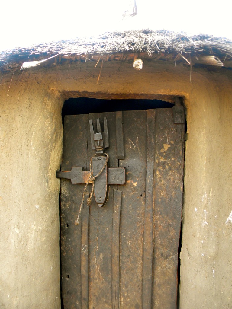 Mali village rural traditional hut design detail door wood carving