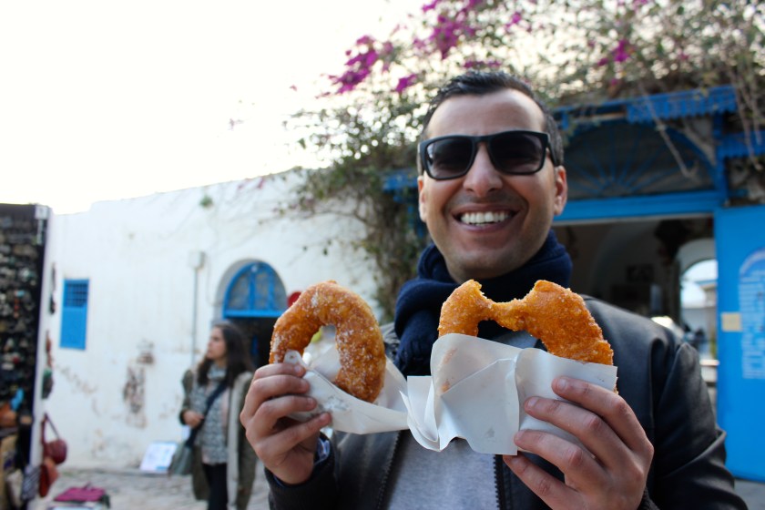 Tunis Tunisia man eat bomboloni bombalouni donut smile