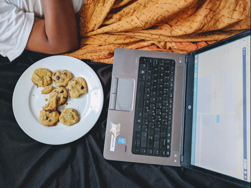 chocolate chip cookies laptop snack bed